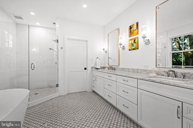 bathroom with vanity and separate shower and tub