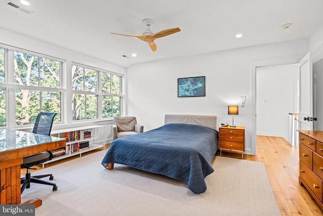 bedroom with ceiling fan, light wood-type flooring, and multiple windows