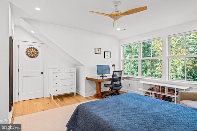 bedroom with light wood-type flooring, vaulted ceiling, and ceiling fan