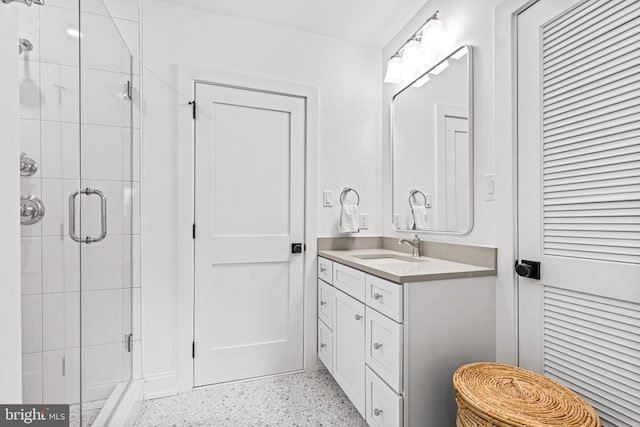 bathroom featuring walk in shower and vanity