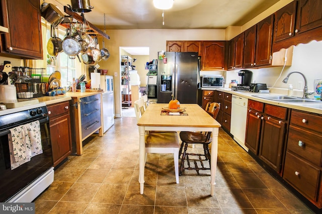 kitchen with stainless steel appliances, light countertops, and a sink