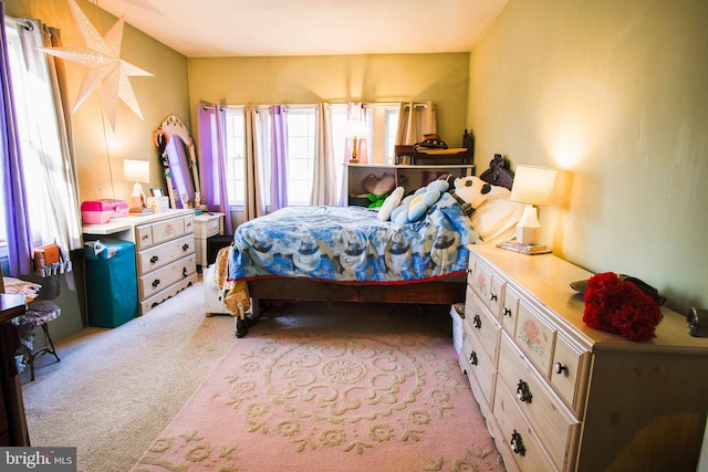 bedroom featuring light carpet