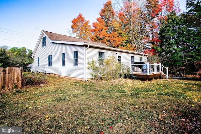 exterior space featuring a lawn and a deck