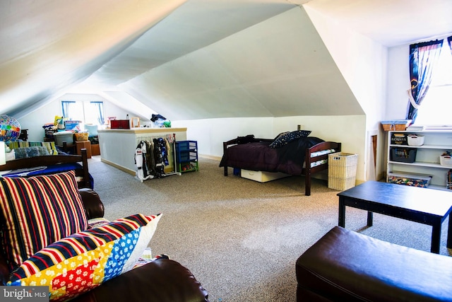 carpeted bedroom with lofted ceiling