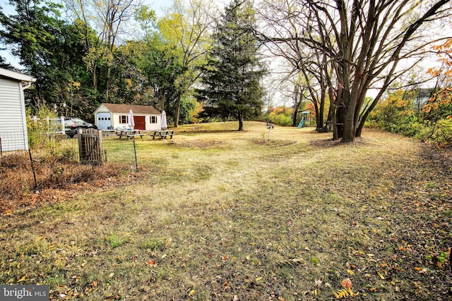 view of yard featuring a playground and an outdoor structure