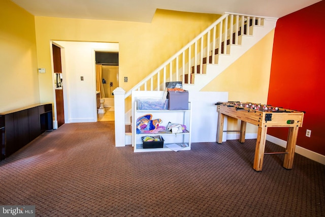 interior space featuring baseboards and carpet floors