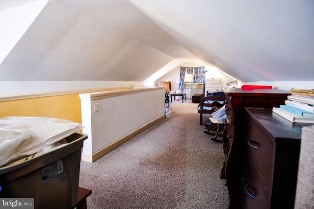 interior space with carpet floors and lofted ceiling