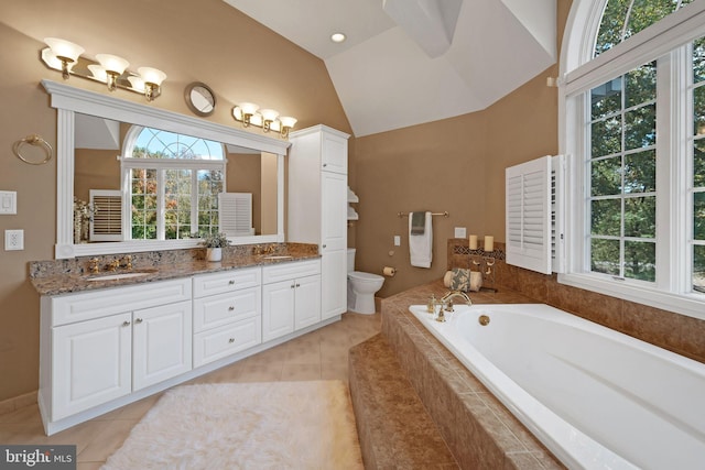 bathroom featuring toilet, lofted ceiling, tile patterned floors, and vanity