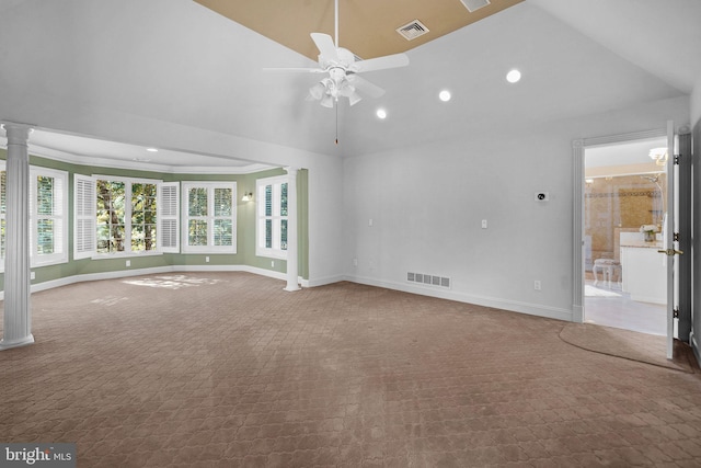 unfurnished living room with carpet, ornamental molding, vaulted ceiling, decorative columns, and ceiling fan