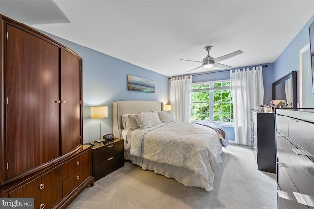 bedroom featuring light carpet and ceiling fan