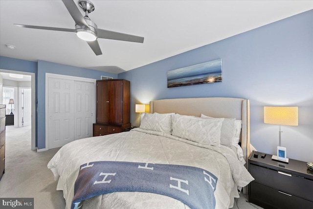 carpeted bedroom with a closet and ceiling fan