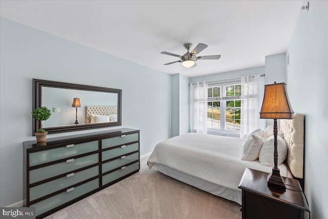 bedroom featuring light carpet and ceiling fan