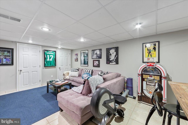 tiled living room with a drop ceiling