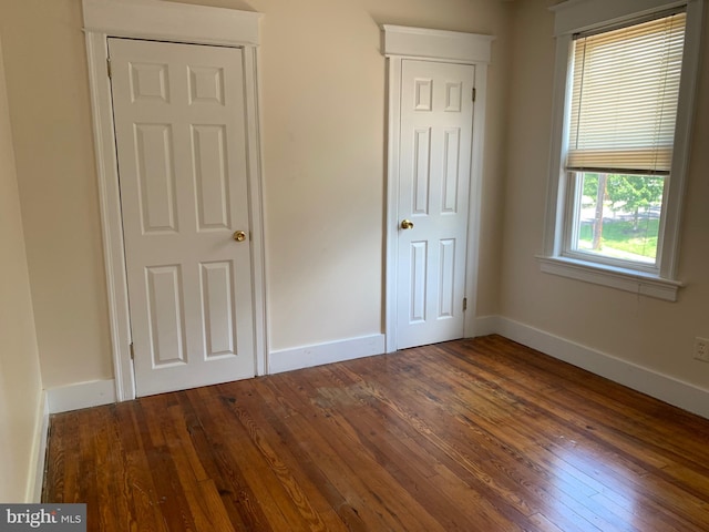 unfurnished bedroom featuring dark hardwood / wood-style floors