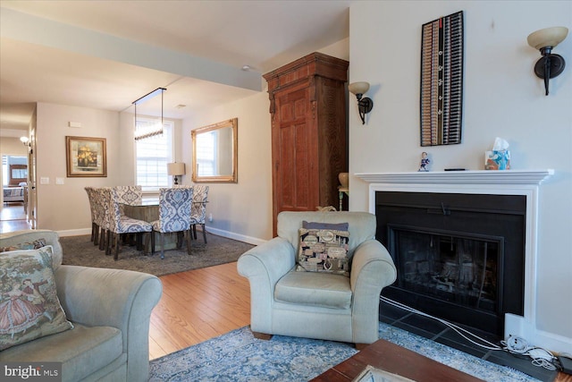 living room featuring a notable chandelier and hardwood / wood-style floors