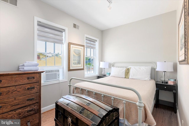 bedroom with hardwood / wood-style flooring