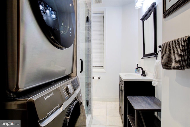 laundry room with stacked washer / drying machine, light tile patterned flooring, and sink