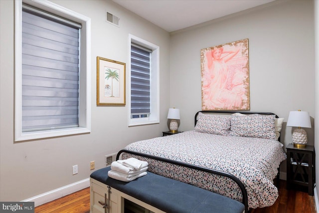 bedroom with hardwood / wood-style floors