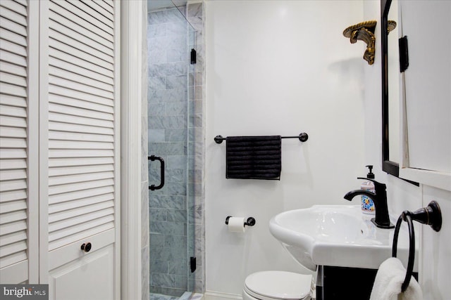 bathroom featuring vanity, an enclosed shower, and toilet