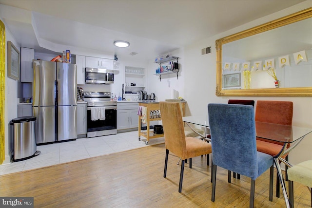 dining space with light hardwood / wood-style flooring