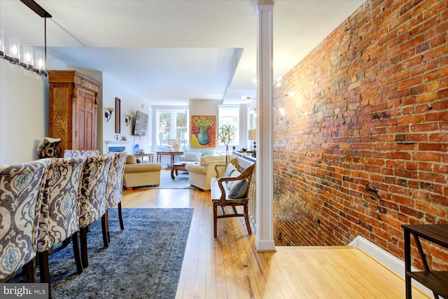 interior space featuring light hardwood / wood-style flooring and brick wall