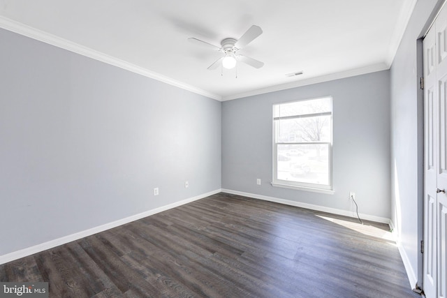 empty room with crown molding, dark wood-type flooring, and ceiling fan