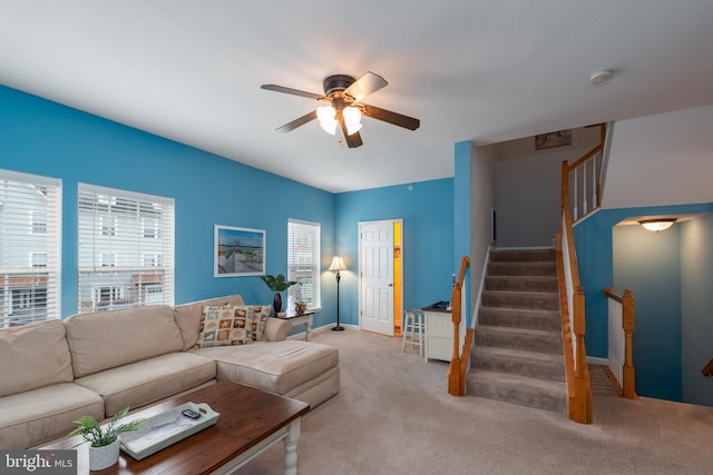 living room featuring ceiling fan and light colored carpet