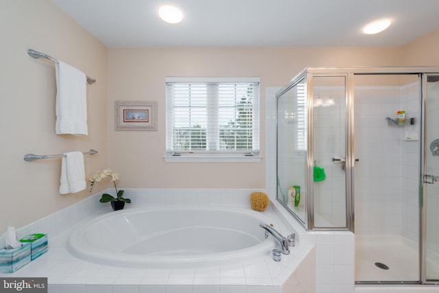 bathroom with shower with separate bathtub