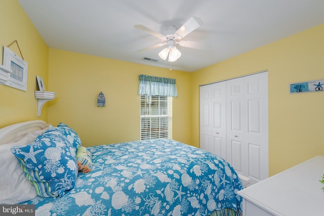 bedroom with ceiling fan and a closet