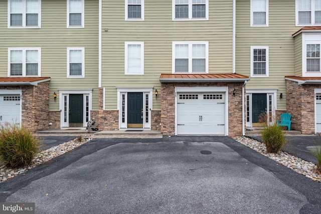 townhome / multi-family property featuring a garage