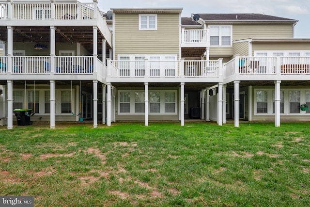 rear view of house featuring a lawn, cooling unit, and a deck