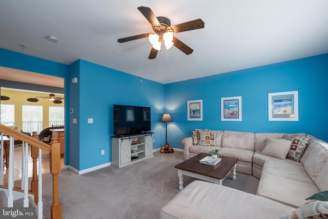 living room with ceiling fan and light colored carpet