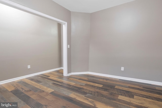 spare room featuring dark hardwood / wood-style flooring