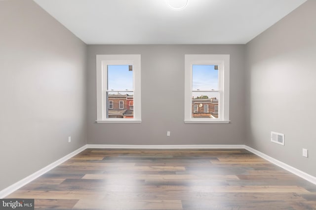 spare room with dark hardwood / wood-style floors