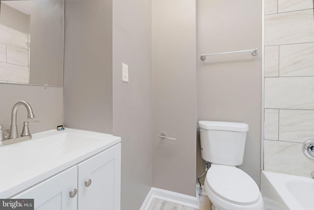 bathroom featuring hardwood / wood-style floors, vanity, and toilet