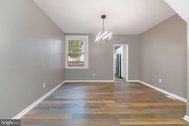 interior space with dark hardwood / wood-style flooring and a notable chandelier