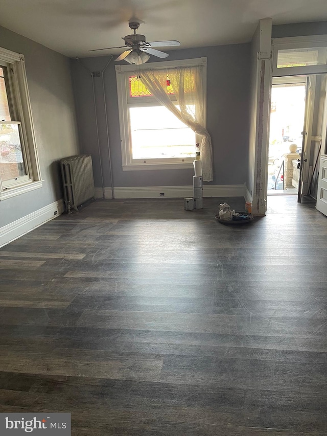 interior space with radiator heating unit, dark hardwood / wood-style flooring, and ceiling fan