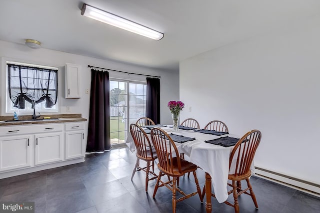 dining space featuring baseboard heating and sink