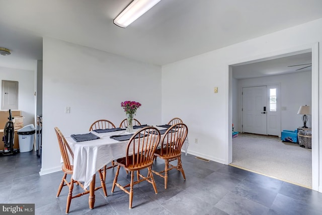 carpeted dining area featuring electric panel