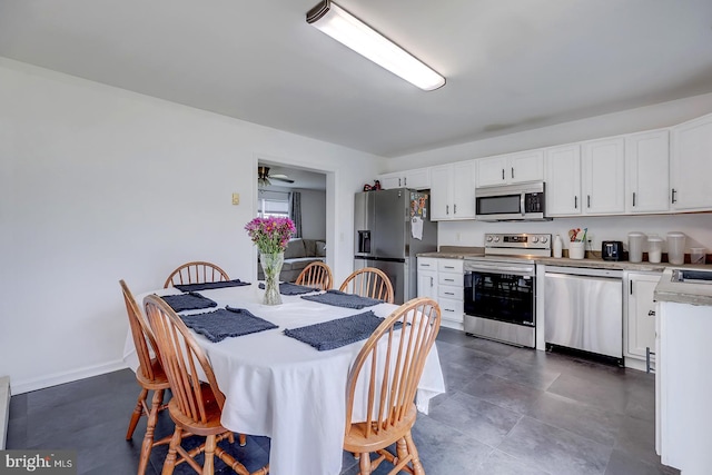 kitchen featuring stainless steel appliances, white cabinets, and ceiling fan