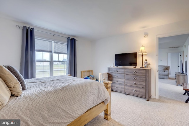 bedroom featuring light colored carpet