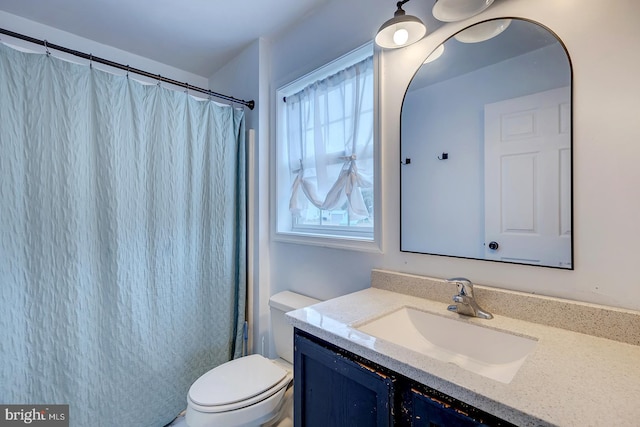 bathroom with vanity, toilet, and a shower with shower curtain