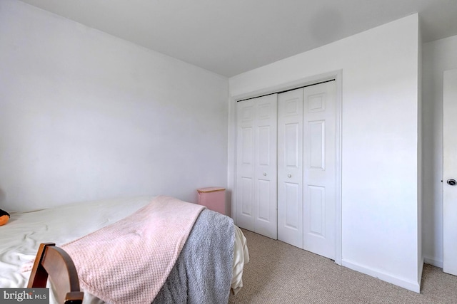 carpeted bedroom featuring a closet