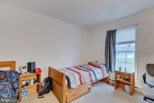 carpeted bedroom with a baseboard heating unit