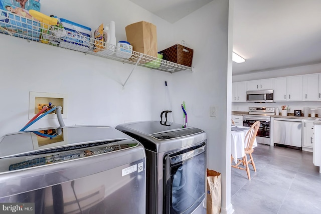 laundry room with separate washer and dryer