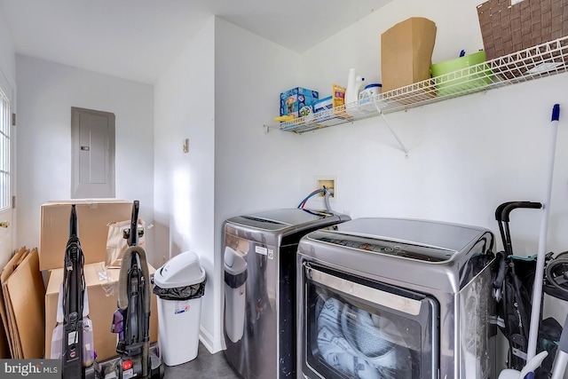 clothes washing area featuring separate washer and dryer and electric panel