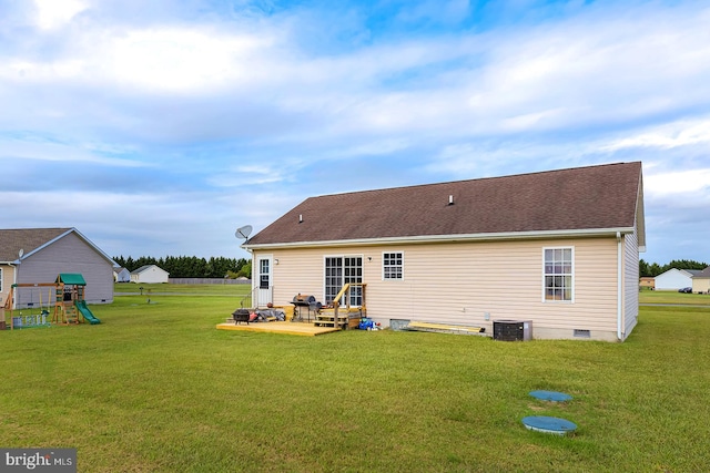 back of property featuring central AC unit, a playground, a patio area, and a yard