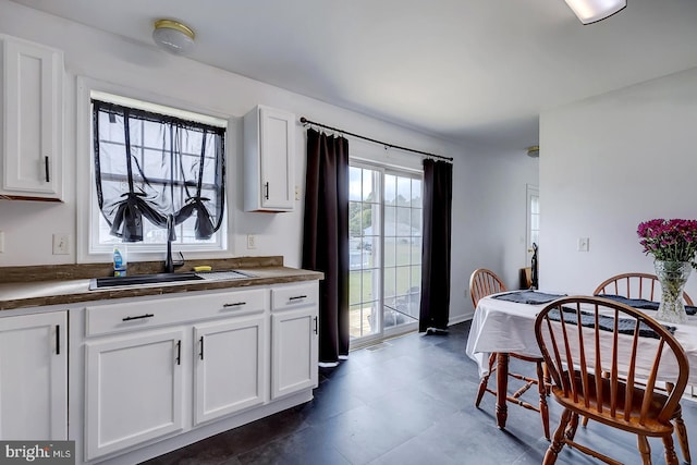 kitchen featuring sink and white cabinets