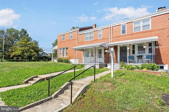 view of front of house featuring a front lawn and covered porch