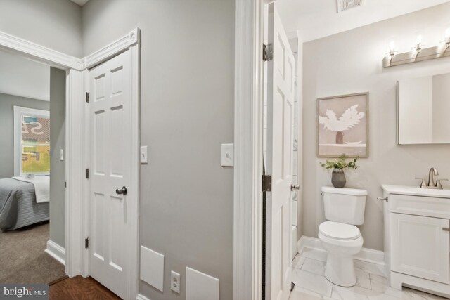 bathroom featuring vanity and toilet